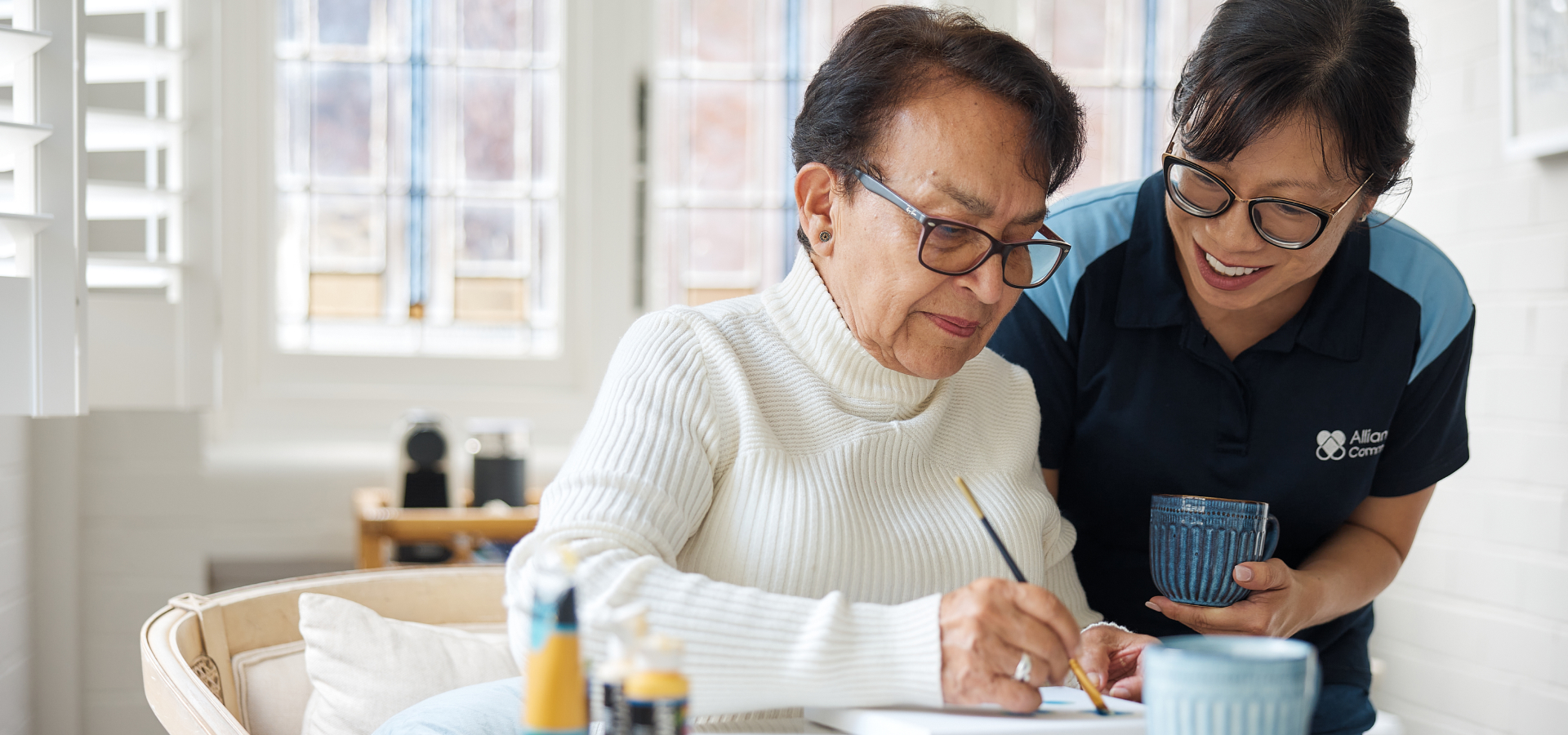 Support worker helping client to paint